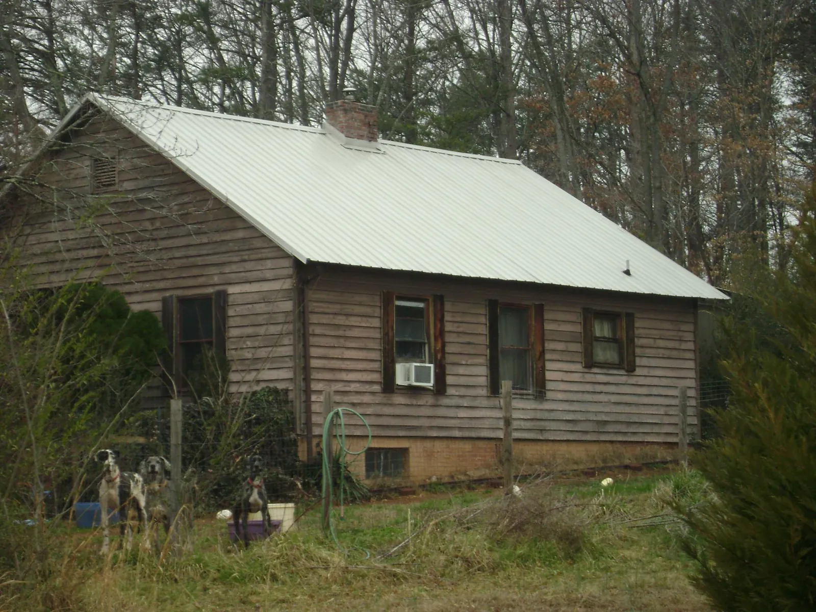 White metal roof on an old wood sided farmhouse, from a Metal Roof Installation job in Rome